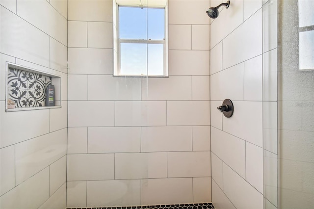 bathroom with a tile shower