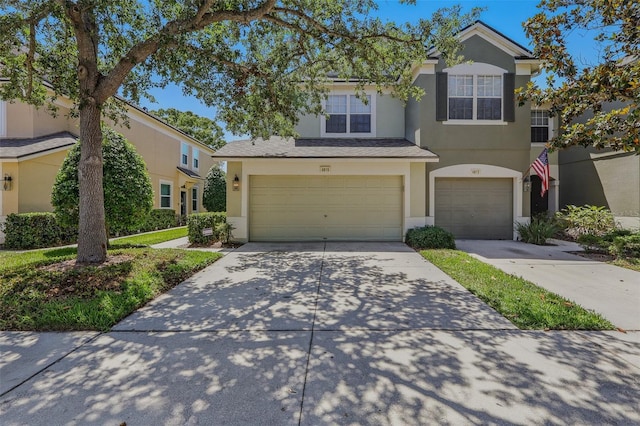 view of front of property with an attached garage, driveway, and stucco siding
