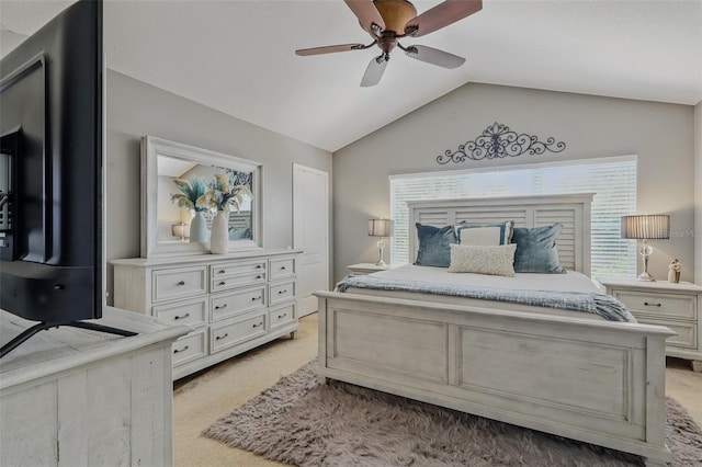 bedroom with a ceiling fan, lofted ceiling, and light carpet