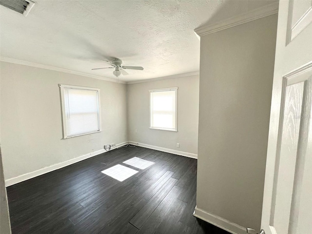 spare room with a ceiling fan, a textured ceiling, visible vents, crown molding, and dark wood-style floors