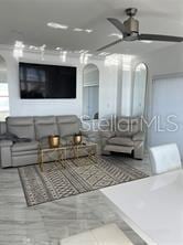 interior space with arched walkways and ceiling fan