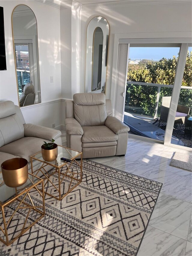 living room featuring arched walkways, plenty of natural light, and marble finish floor
