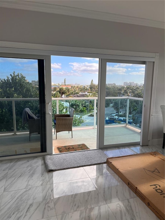 doorway to outside with crown molding and a city view