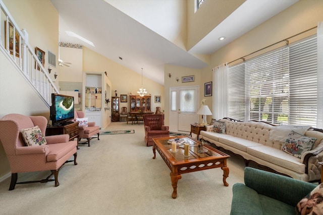 living room featuring a high ceiling, carpet flooring, stairs, and a notable chandelier