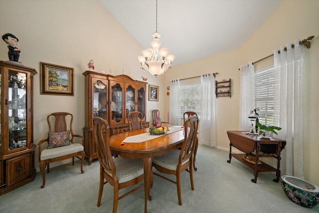 dining space featuring high vaulted ceiling, light colored carpet, and a chandelier