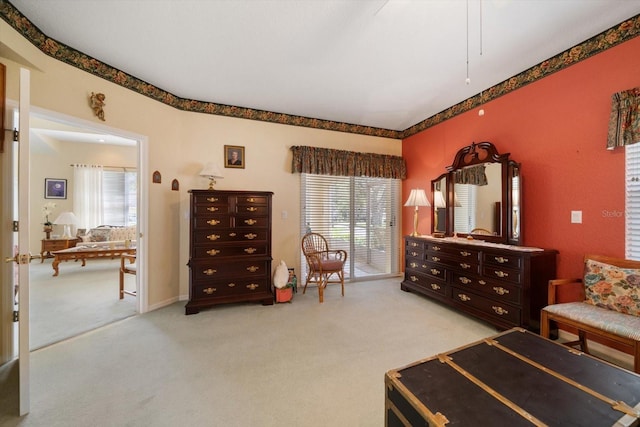 bedroom with light colored carpet and multiple windows