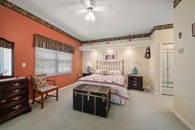 bedroom featuring baseboards, a ceiling fan, and light colored carpet