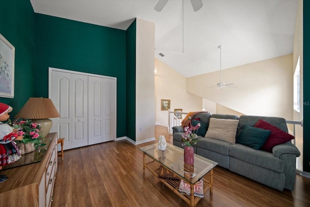 living area featuring baseboards, a ceiling fan, high vaulted ceiling, and wood finished floors