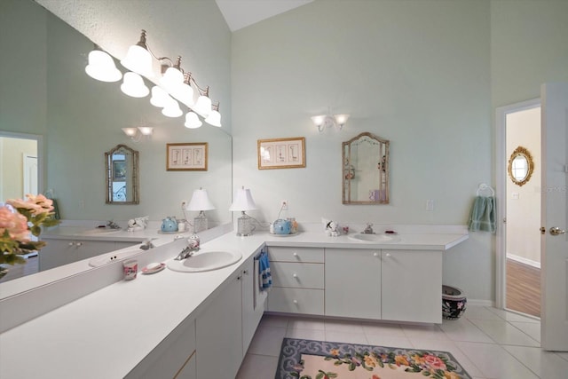 full bath with a sink, high vaulted ceiling, and tile patterned flooring