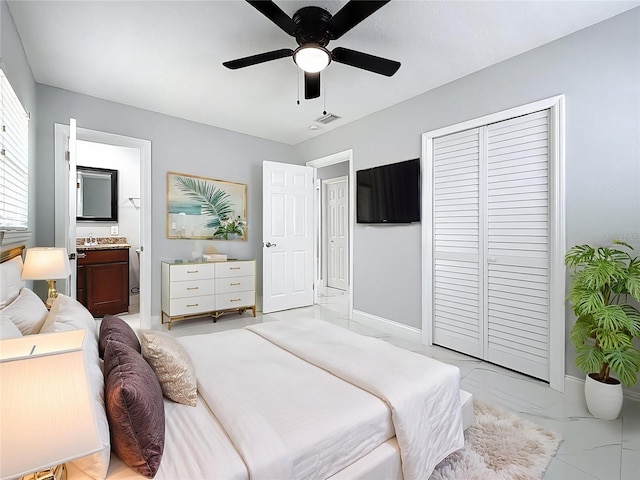 bedroom with marble finish floor, a closet, baseboards, and visible vents