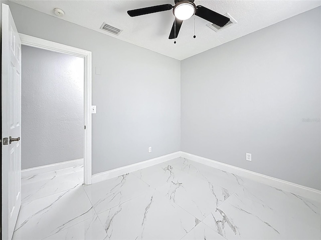 unfurnished room featuring visible vents, marble finish floor, baseboards, and ceiling fan
