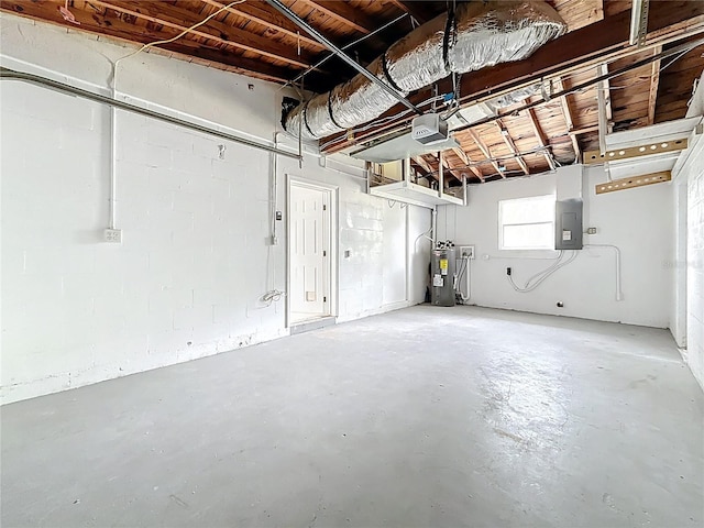 garage featuring electric water heater, electric panel, and a garage door opener