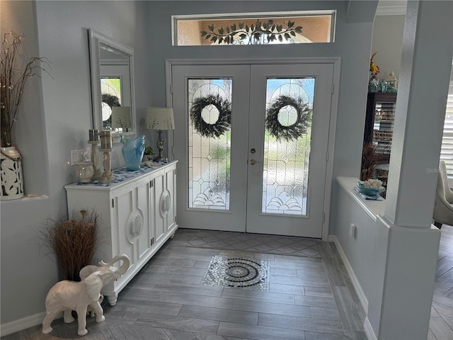2908 89th Ave E, Parrish, FL 34219 - entryway featuring french doors, wood finished floors, healthy amount of natural light, and baseboards