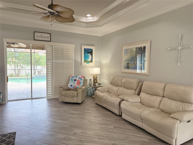 2908 89th Ave E, Parrish, FL 34219 - living area featuring crown molding, a ceiling fan, wood finished floors, a tray ceiling, and recessed lighting