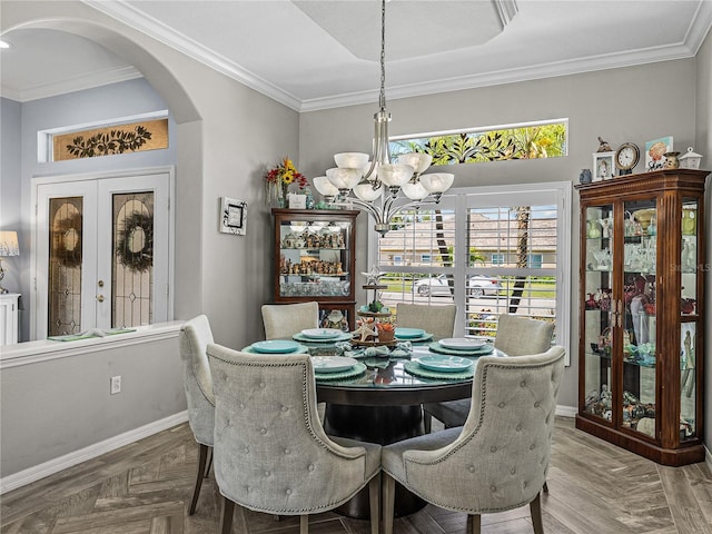 2908 89th Ave E, Parrish, FL 34219 - dining room featuring arched walkways, a chandelier, crown molding, baseboards, and french doors