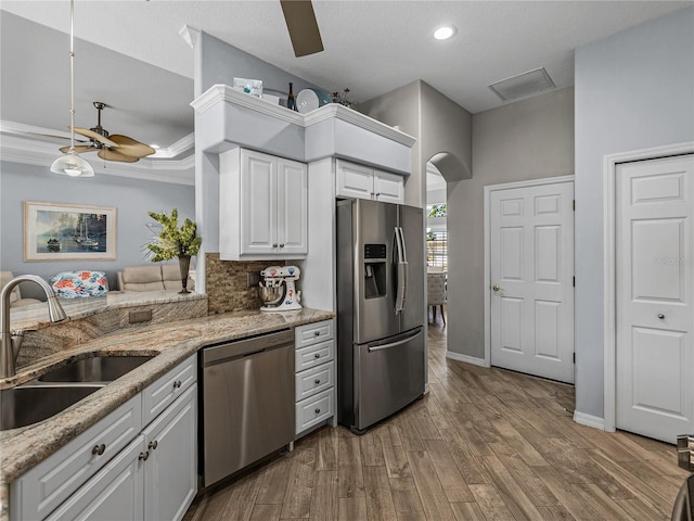 2908 89th Ave E, Parrish, FL 34219 - kitchen featuring appliances with stainless steel finishes, a sink, a ceiling fan, white cabinetry, and wood finished floors