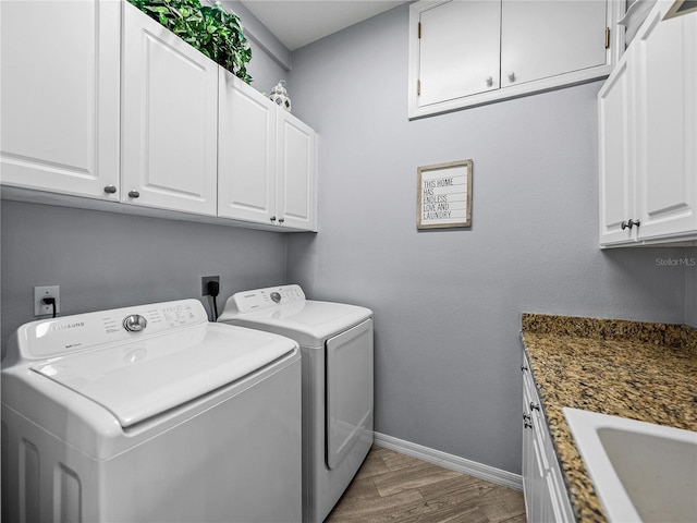 2908 89th Ave E, Parrish, FL 34219 - laundry area with cabinet space, washer and dryer, baseboards, and wood finished floors
