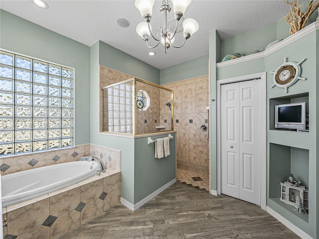 2908 89th Ave E, Parrish, FL 34219 - full bathroom with a bath, a chandelier, a walk in shower, wood finished floors, and baseboards