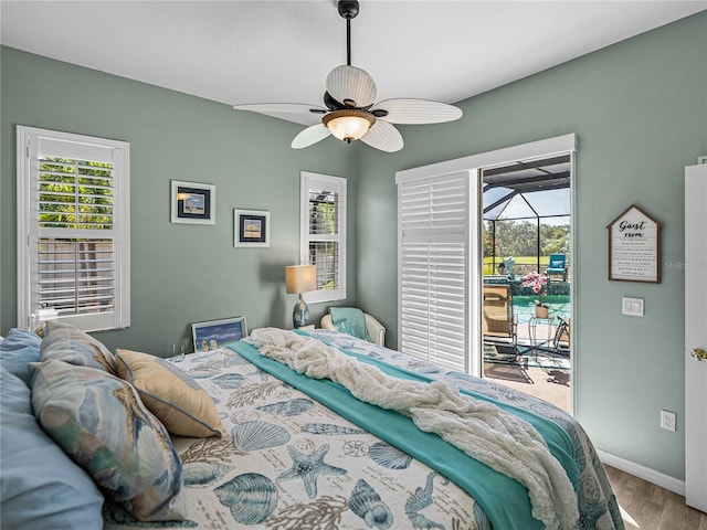 2908 89th Ave E, Parrish, FL 34219 - bedroom featuring access to outside, wood finished floors, and multiple windows