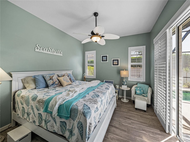 2908 89th Ave E, Parrish, FL 34219 - bedroom featuring access to exterior, wood finished floors, vaulted ceiling, baseboards, and ceiling fan