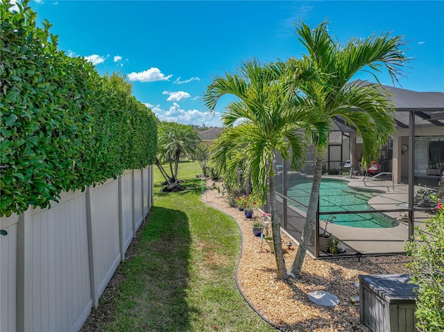 2908 89th Ave E, Parrish, FL 34219 - view of grassy yard with glass enclosure, a patio area, and an outdoor pool