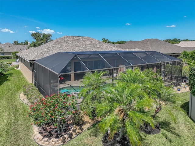 2908 89th Ave E, Parrish, FL 34219 - back of house with an outdoor pool, roof with shingles, a lawn, glass enclosure, and a patio