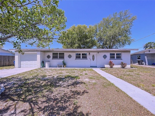 ranch-style house featuring driveway, a front yard, brick siding, fence, and an attached garage