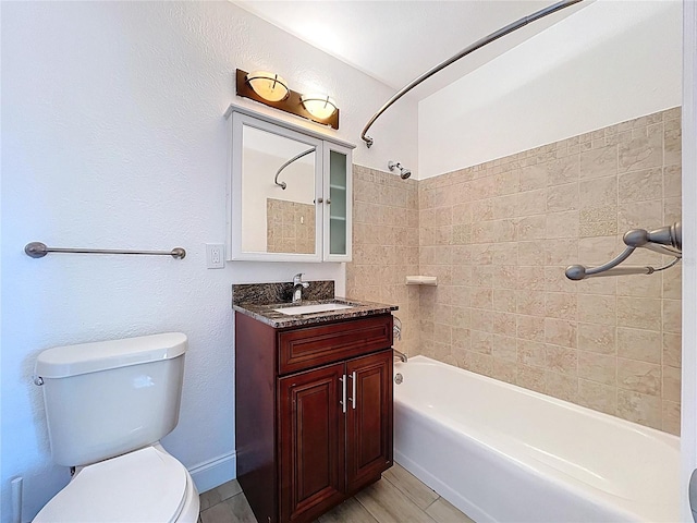 bathroom featuring vanity, bathtub / shower combination, and toilet