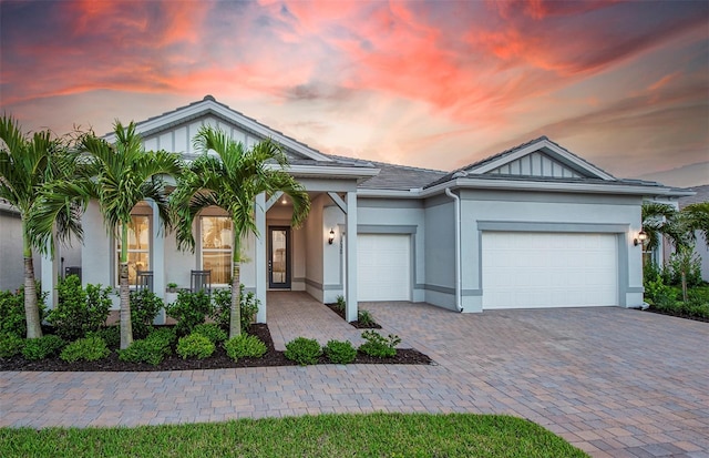 14727 Eagle Branch Dr, Nokomis, FL 34275 - single story home featuring a garage, stucco siding, and decorative driveway