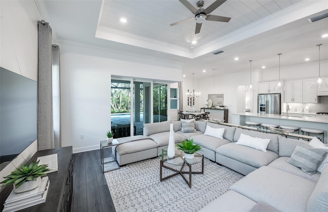 14727 Eagle Branch Dr, Nokomis, FL 34275 - living room with ceiling fan, a raised ceiling, visible vents, ornamental molding, and hardwood / wood-style flooring