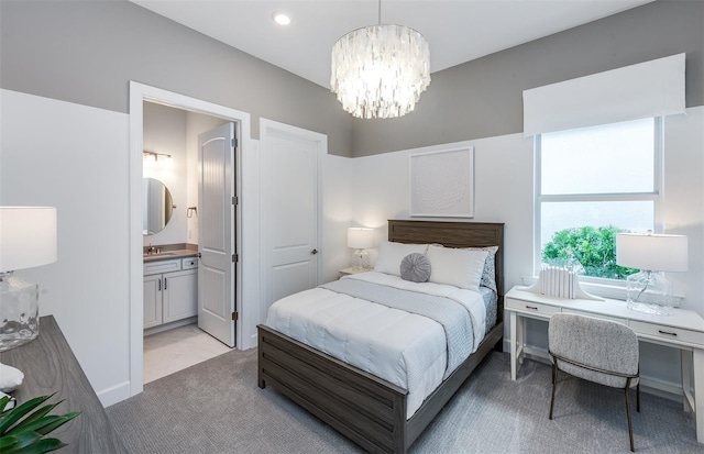 14727 Eagle Branch Dr, Nokomis, FL 34275 - bedroom with light carpet, recessed lighting, connected bathroom, a sink, and a notable chandelier
