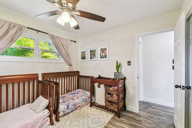 bedroom featuring baseboards, ceiling fan, and wood finished floors