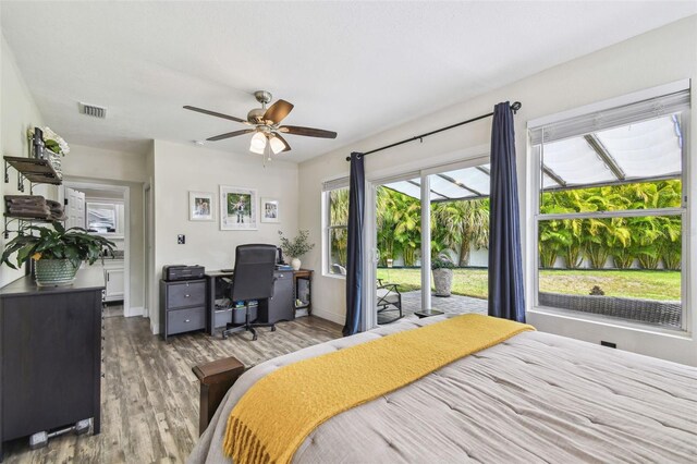 bedroom featuring light wood finished floors, access to exterior, a ceiling fan, baseboards, and visible vents
