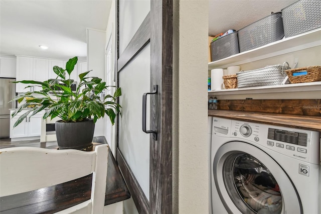 laundry room with laundry area and washer / clothes dryer