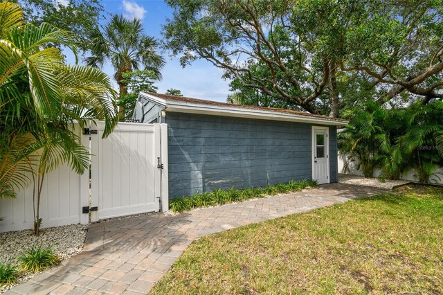 garage with a gate and fence