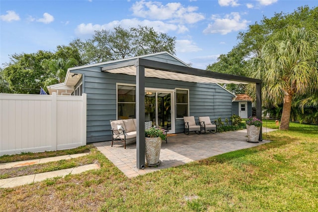 back of house with a yard, a patio, and fence