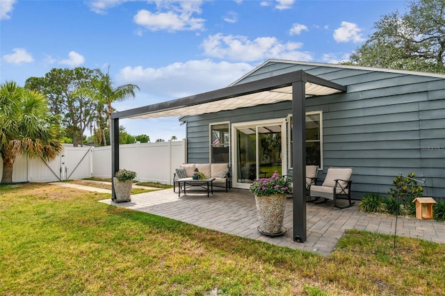 back of house featuring a lawn, a gate, fence, a patio, and outdoor lounge area