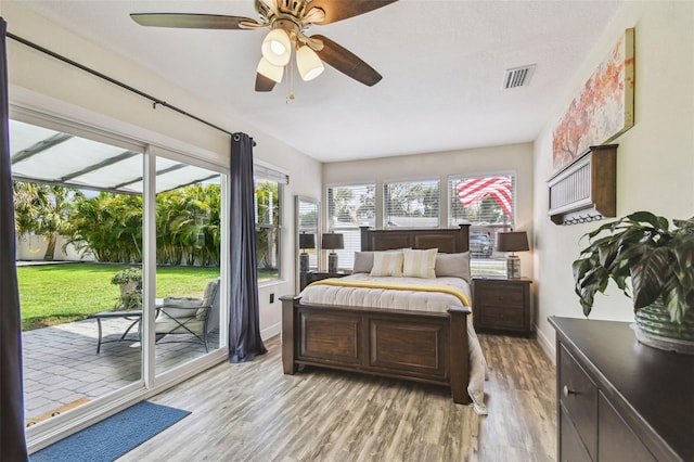 4403 W Bay Court Ave, Tampa, FL 33611 - bedroom featuring access to exterior, light wood-type flooring, baseboards, and ceiling fan