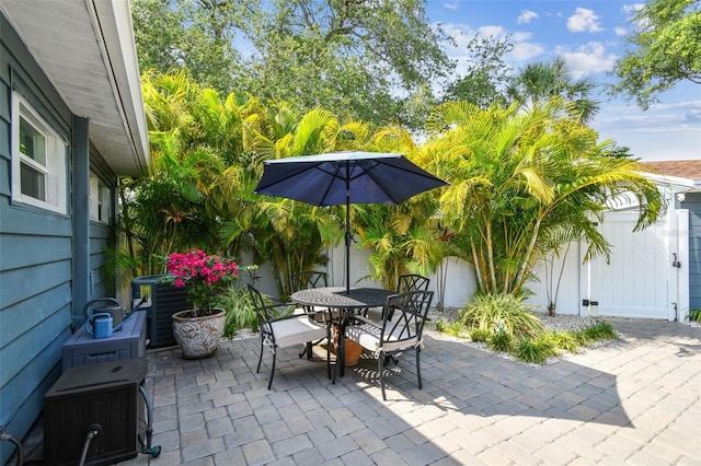 4403 W Bay Court Ave, Tampa, FL 33611 - view of patio with outdoor dining area, central AC unit, and a fenced backyard