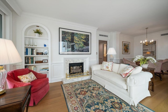4 Belleview Blvd Unit 802, Belleair, FL 33756 - living room with ornamental molding, wood finished floors, a notable chandelier, and a premium fireplace