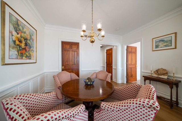 4 Belleview Blvd Unit 802, Belleair, FL 33756 - dining room with wood finished floors, a wainscoted wall, a notable chandelier, ornamental molding, and a decorative wall