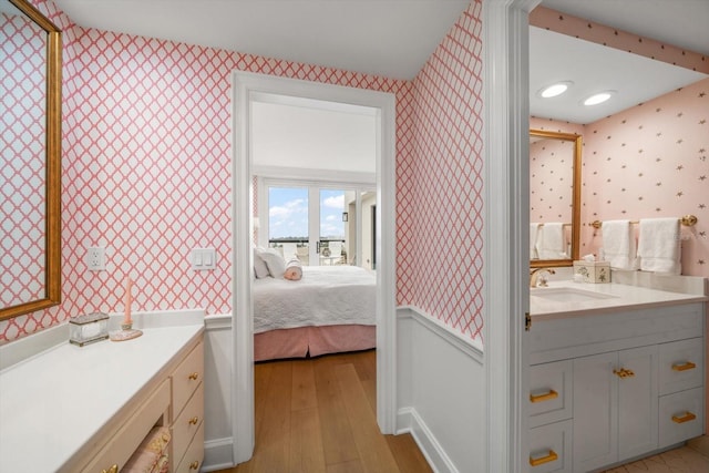 4 Belleview Blvd Unit 802, Belleair, FL 33756 - ensuite bathroom with wood-type flooring, connected bathroom, vanity, and wallpapered walls