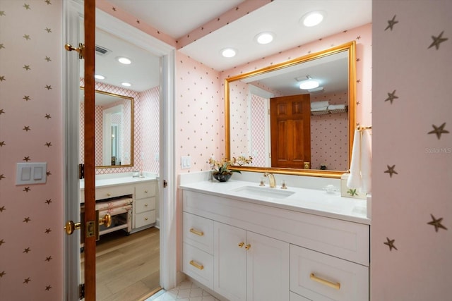 4 Belleview Blvd Unit 802, Belleair, FL 33756 - bathroom featuring recessed lighting, vanity, and wallpapered walls