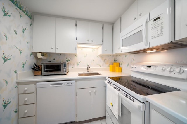 4 Belleview Blvd Unit 802, Belleair, FL 33756 - kitchen with white appliances, wallpapered walls, light countertops, white cabinets, and a sink