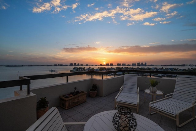 4 Belleview Blvd Unit 802, Belleair, FL 33756 - patio terrace at dusk featuring a water view, a city view, and outdoor dining area