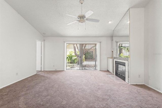 unfurnished living room with light colored carpet, a ceiling fan, a textured ceiling, and lofted ceiling