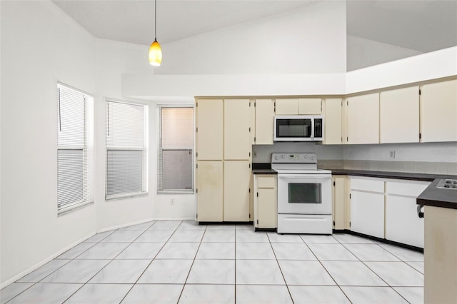 kitchen with dark countertops, white appliances, high vaulted ceiling, cream cabinetry, and pendant lighting