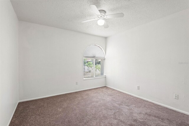 unfurnished room featuring baseboards, a ceiling fan, carpet flooring, and a textured ceiling