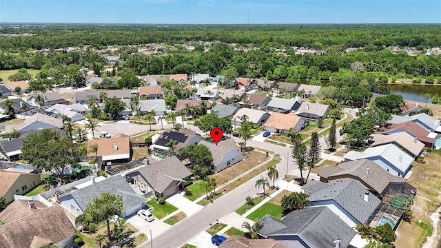 aerial view featuring a residential view and a wooded view