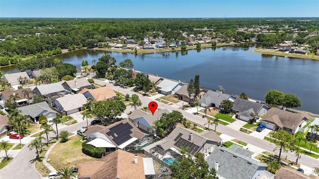 drone / aerial view featuring a water view and a residential view